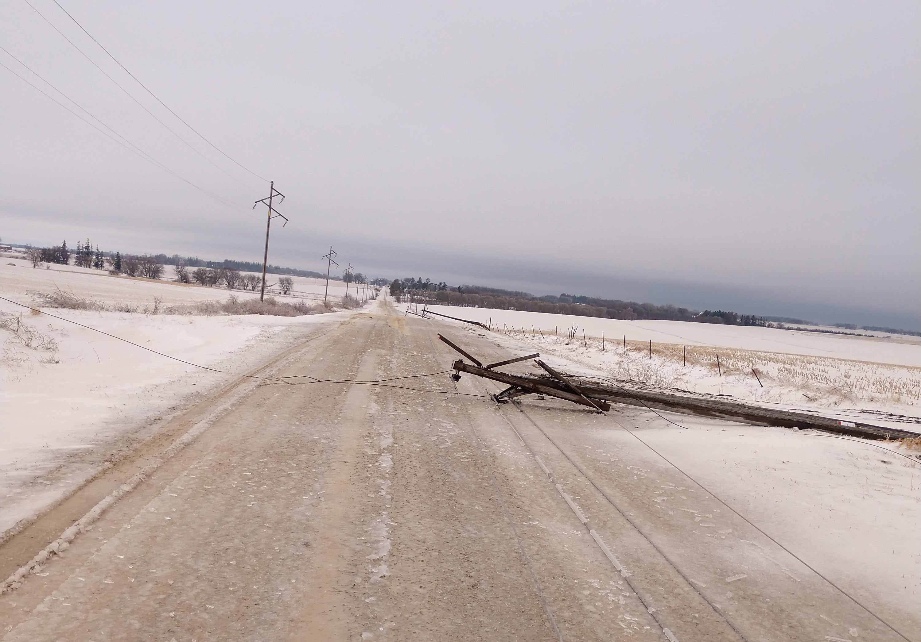 photo showing pole laying across road